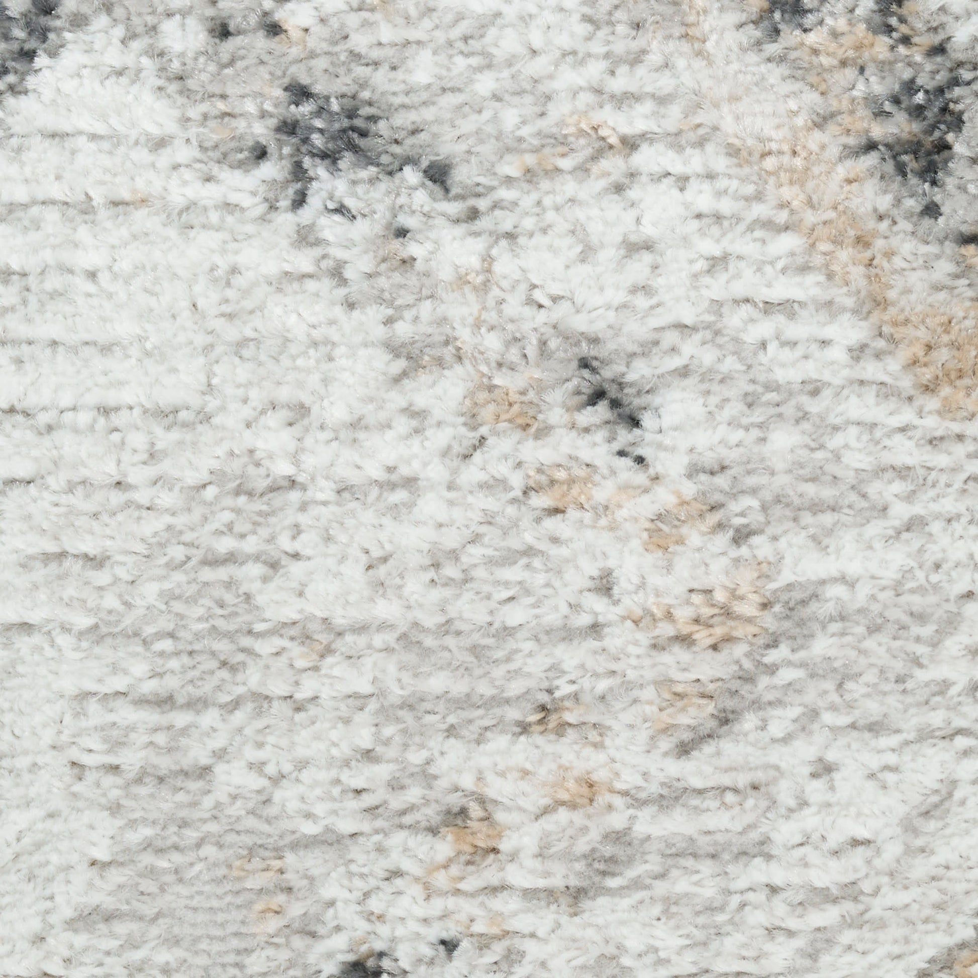 Close-up of a fluffy light gray shag rug with cream and beige flecks.