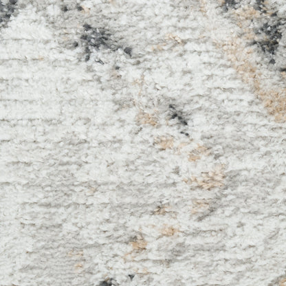 Close-up of a fluffy light gray shag rug with cream and beige flecks.