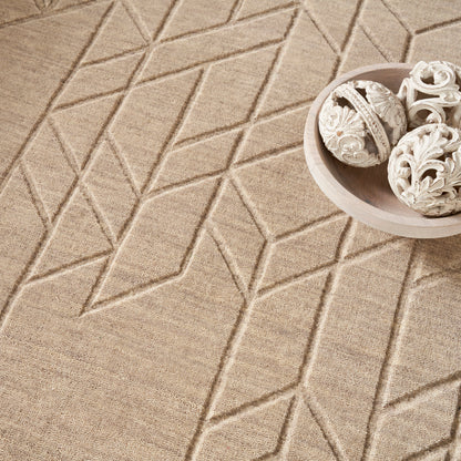 Beige geometric rug with raised diamond pattern; round light wood bowl containing white carved ornamental spheres.