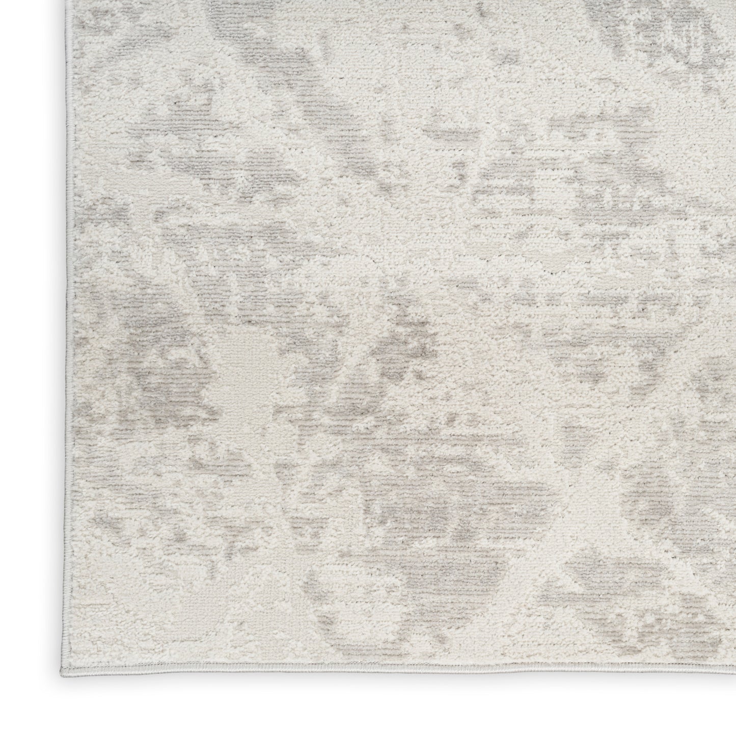 Beige and gray abstract-pattern rug with soft plush pile and subtle mottled shading.