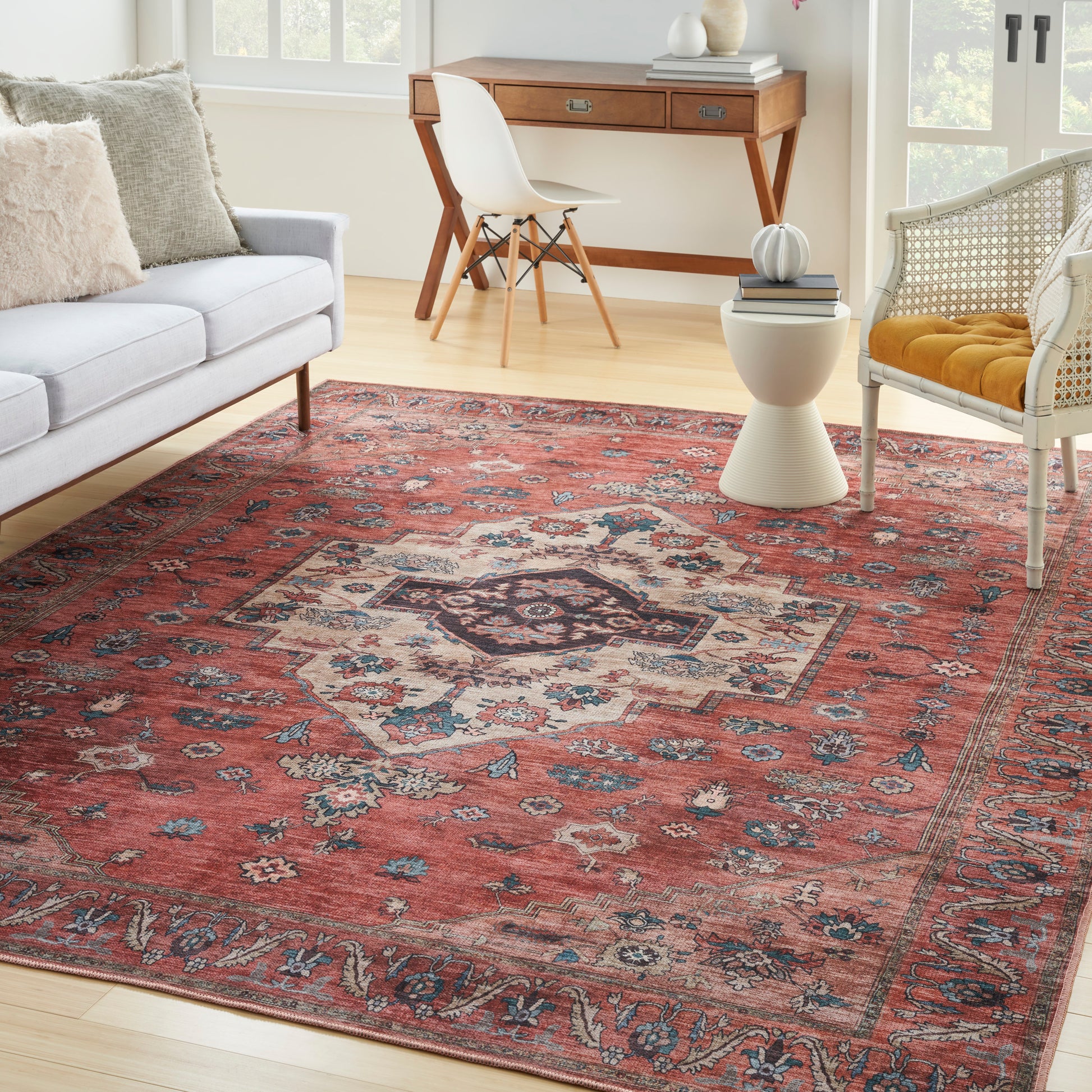 Persian-style red area rug with central medallion, blue and cream motifs, ideal for a cozy living room seating area.