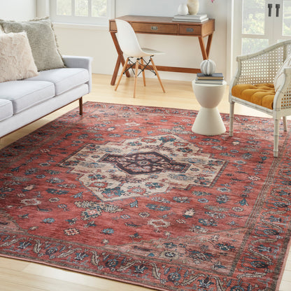 Persian-style red area rug with central medallion, blue and cream motifs, ideal for a cozy living room seating area.