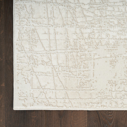 Rectangular beige area rug (8' x 10') with a soft, textured geometric pattern on dark wood floor