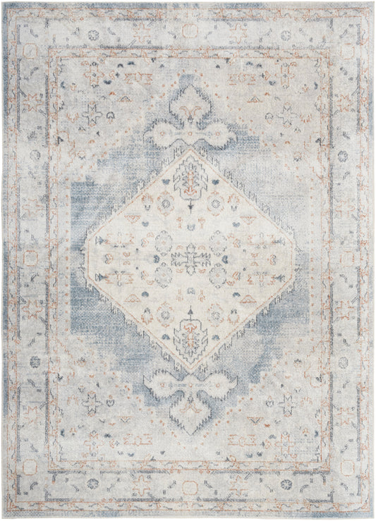 Distressed vintage-style oriental rug in soft blue and ivory with a diamond medallion and faded floral border.