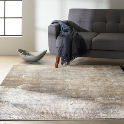Grey modern rug with a beige pattern on a light wood floor, with a ceramic bowl nearby.