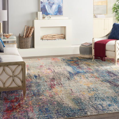 Living room with colorful abstract rug, white fireplace, beige metal-frame sofa, and cream armchair with burgundy throw.