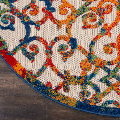 Round multicolor rug with ornate scroll pattern in orange, blue, teal on beige; thick tufted pile and blue edge.
