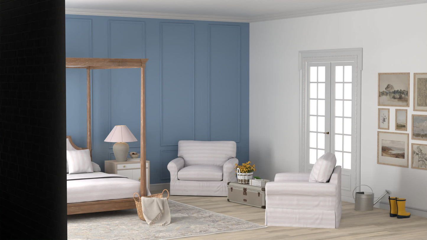 8' x 10' rug in a bedroom scene with a wooden canopy bed, white bedding, a sofa, an armchair, a lamp & a plant.