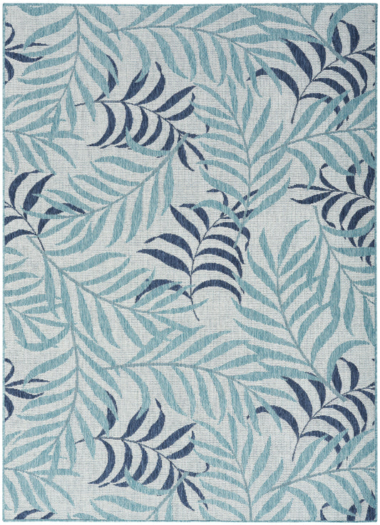 Rectangular rug with teal and navy palm-leaf pattern on a pale blue background; woven textile.