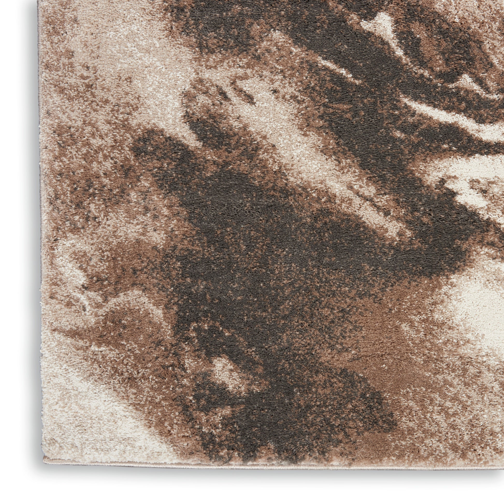 Close-up of a beige rug runner with an irregular dark brown marbled pattern and a textured surface.
