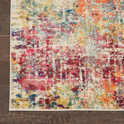 Abstract multicolor area rug with cream background and pink, blue, yellow splashes; shaggy tufted pile on wood floor.
