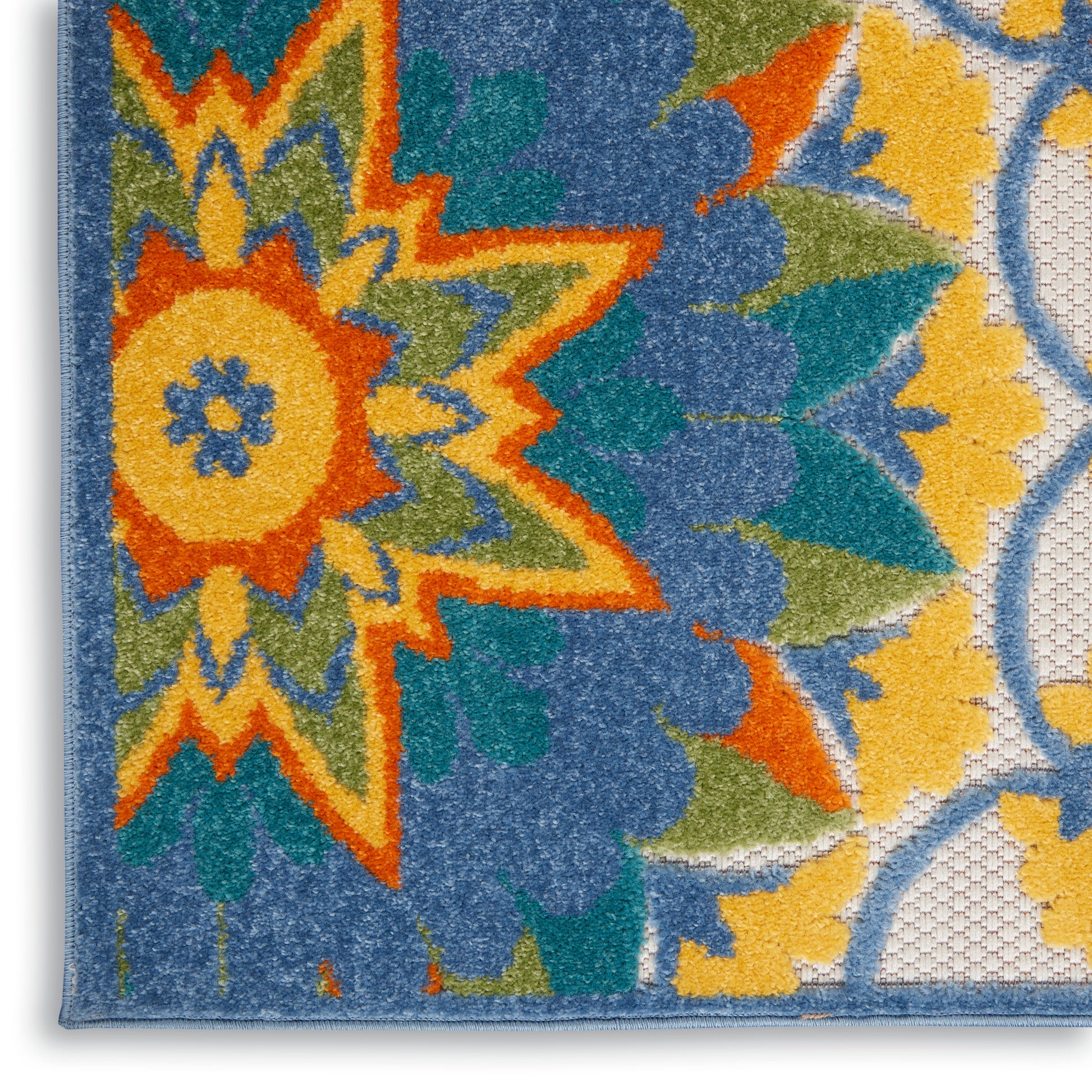 Tufted area rug with a bold multicolor floral starburst in orange, yellow, teal and blue, bordered in blue.