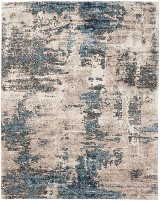 Rectangular distressed abstract rug in beige with blue-gray patches; vintage-look area rug for living room or bedroom.