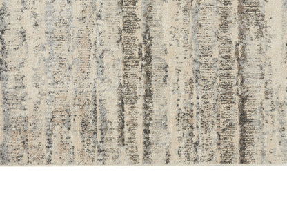 Beige and gray abstract area rug with vertical charcoal streaks and a soft, distressed finish.