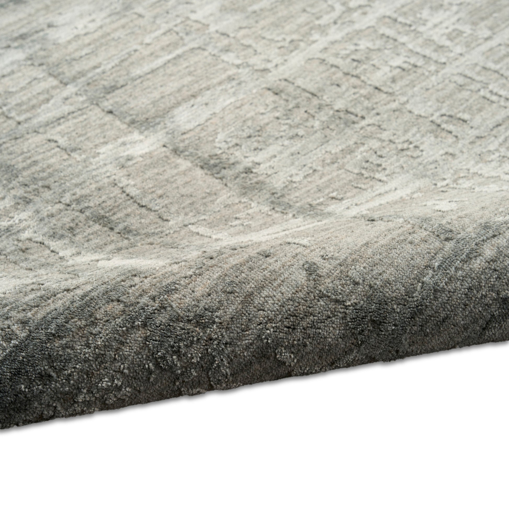 Grey geometric area rug with textured pattern, soft plush pile and rolled edge.