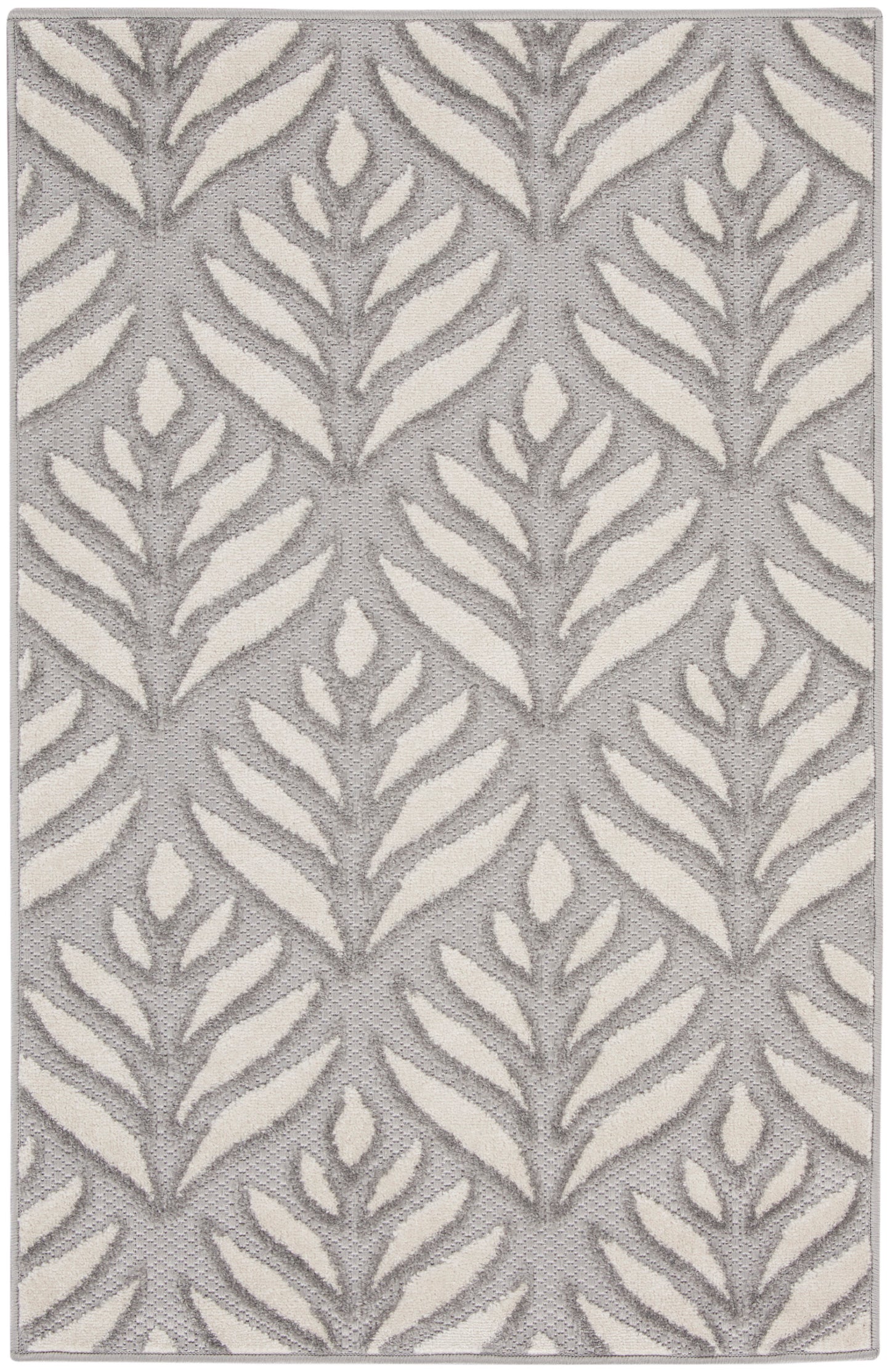 Gray rug with cream fern-like leaf pattern, textured woven surface, modern botanical design.