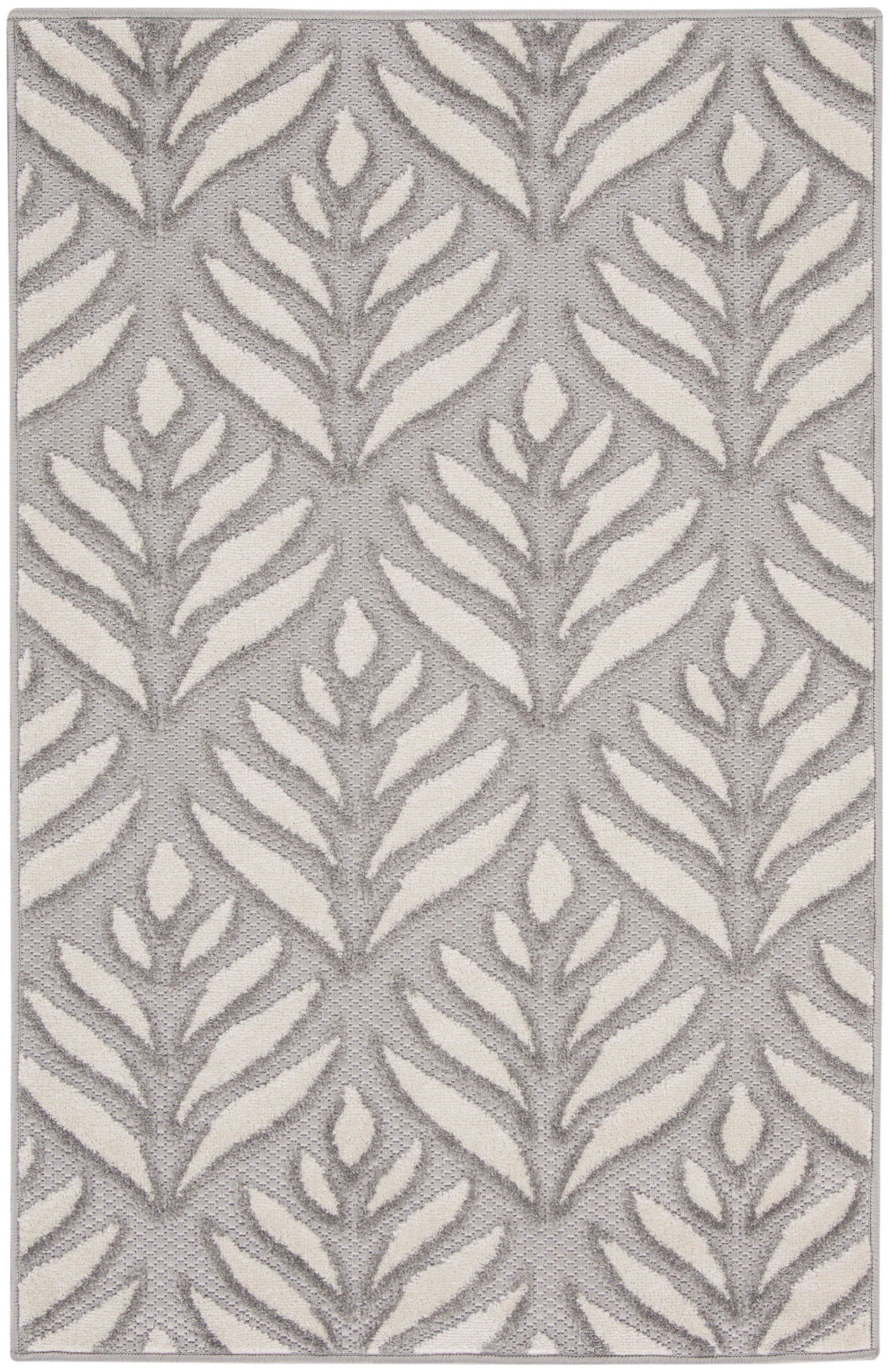 Gray rug with cream fern-like leaf pattern, textured woven surface, modern botanical design.