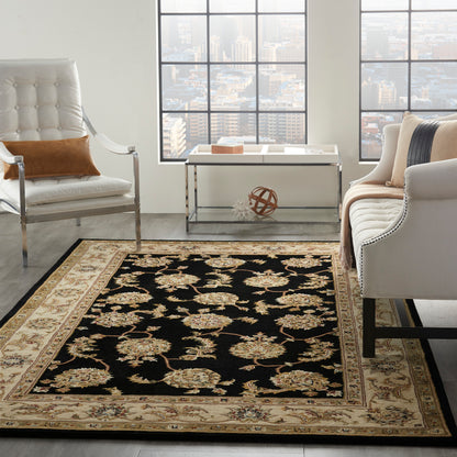 Black rectangular oriental area rug with beige & gold floral motifs and a pale beige border.