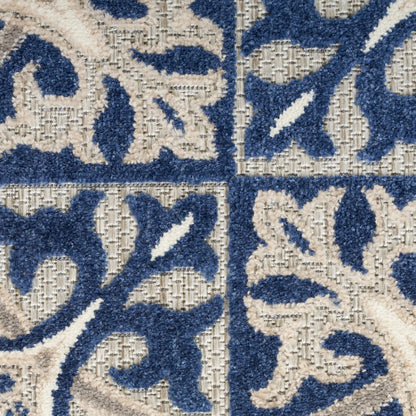 Blue and beige tufted area rug with floral arabesque tile pattern and plush texture.