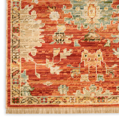 Red-orange oriental rug with cream and light blue geometric motifs and fringed edges.