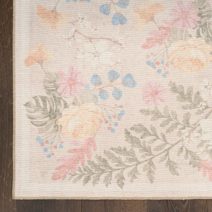 Pastel floral rug with peach roses, pink blossoms, blue accents and gray-green ferns on beige background; wood edge visible.