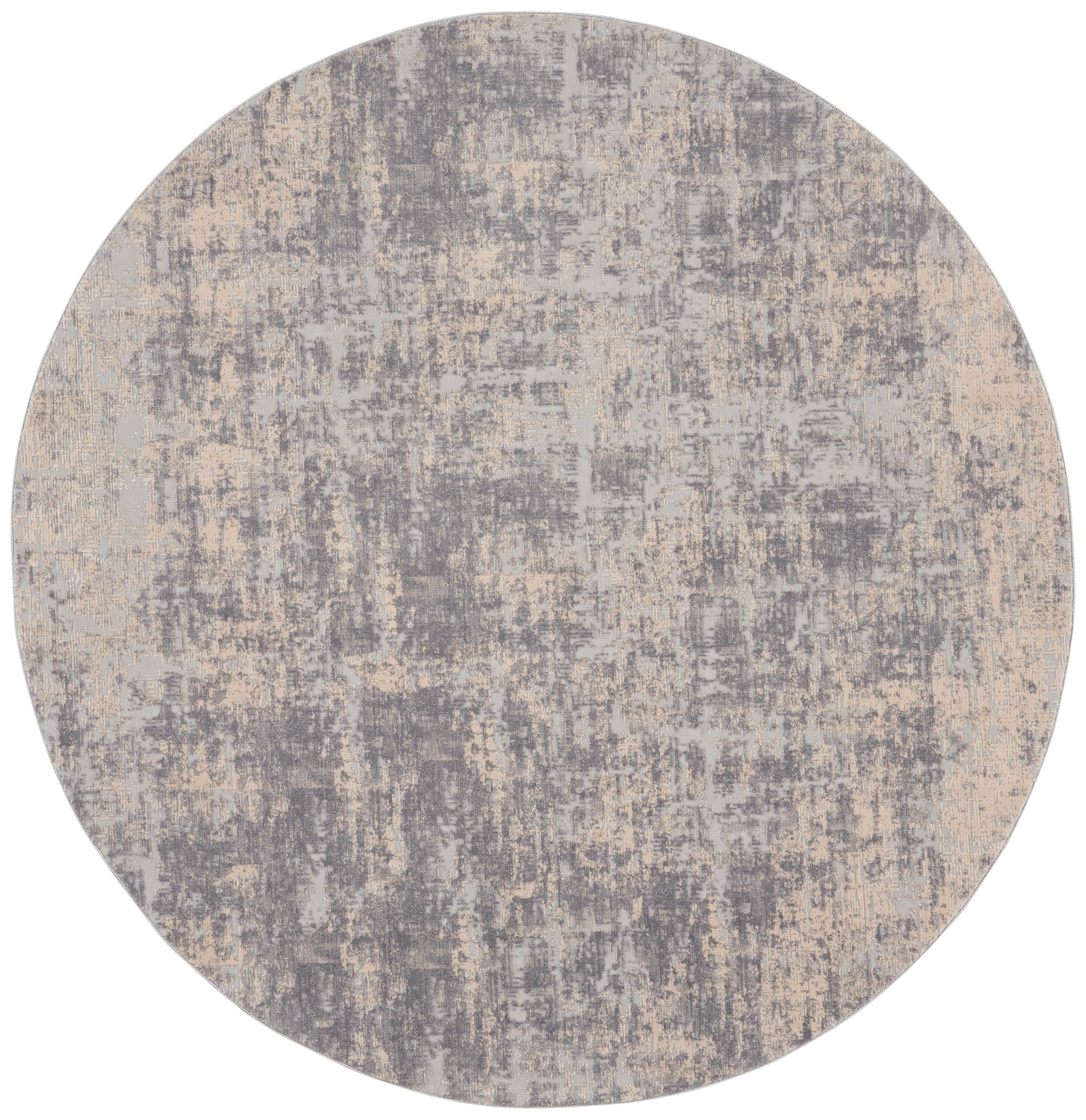 Round abstract rug in gray and beige with distressed, mottled pattern; modern, soft textile.