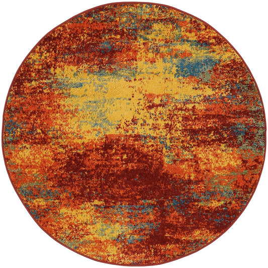 Round abstract rug with burnt orange, yellow and blue patches in a distressed multicolor pattern.