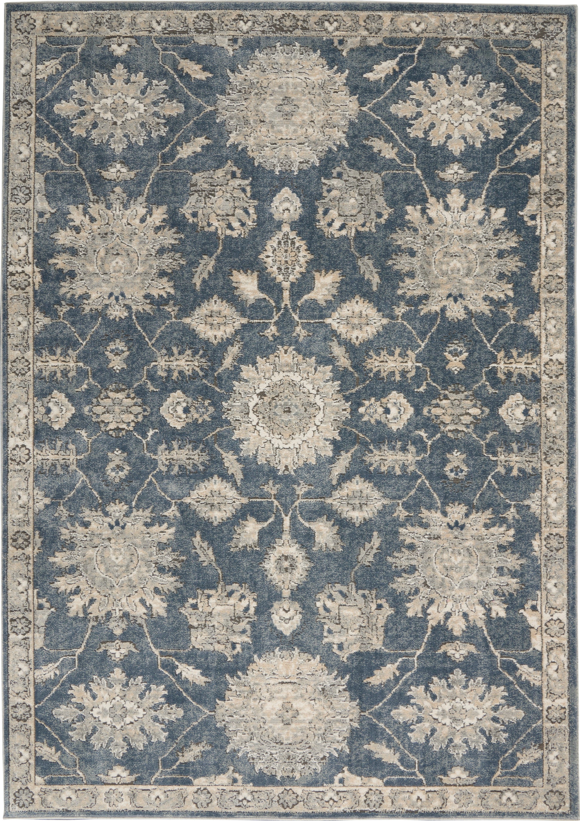 Blue field, ivory floral Persian-style rectangular area rug with scrolling vines and decorative border.