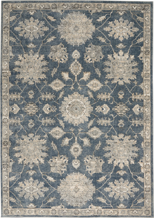 Blue field, ivory floral Persian-style rectangular area rug with scrolling vines and decorative border.