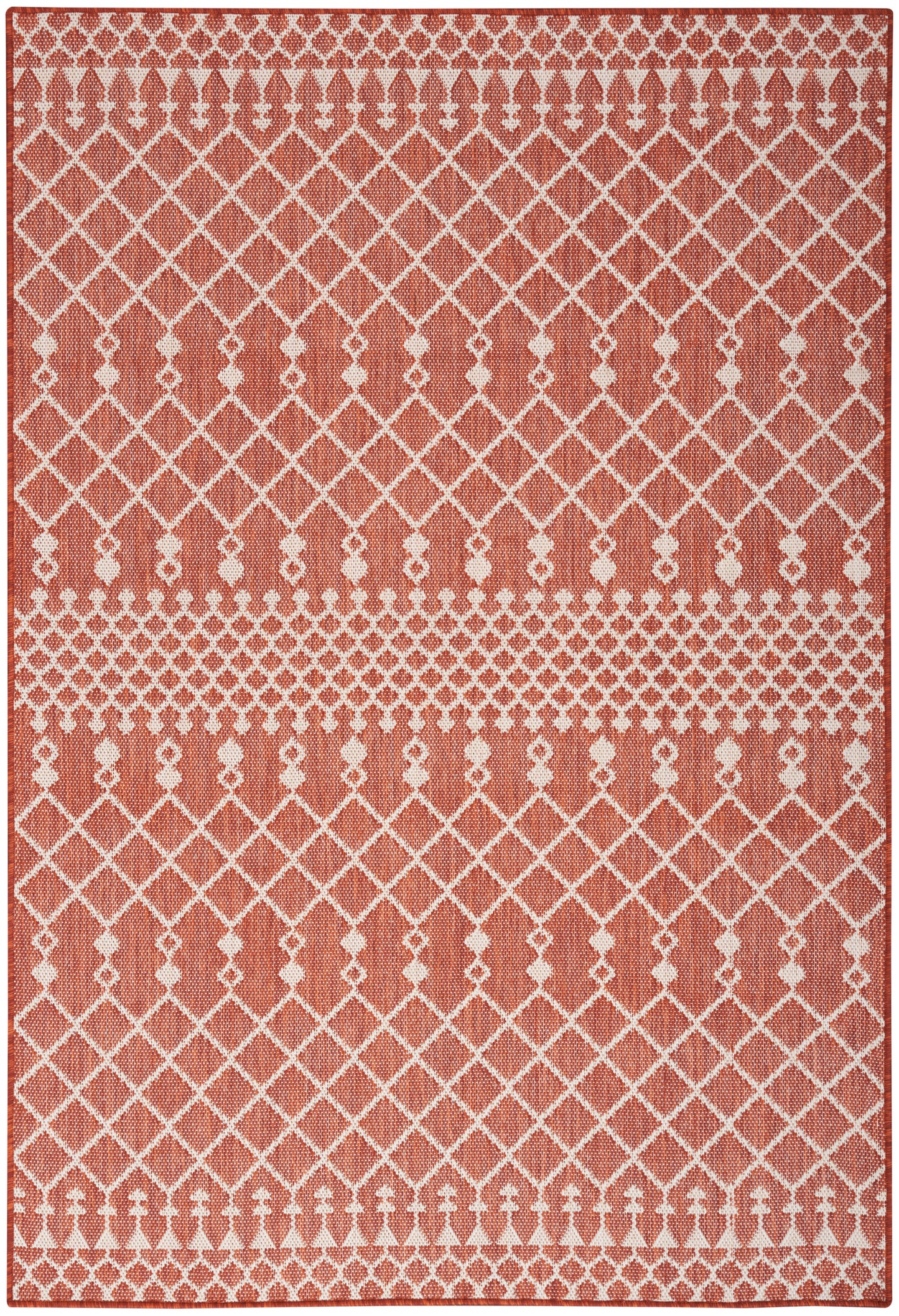 Rust-orange rug with white lattice diamond pattern and decorative borders of rosettes and dots; textured weave.