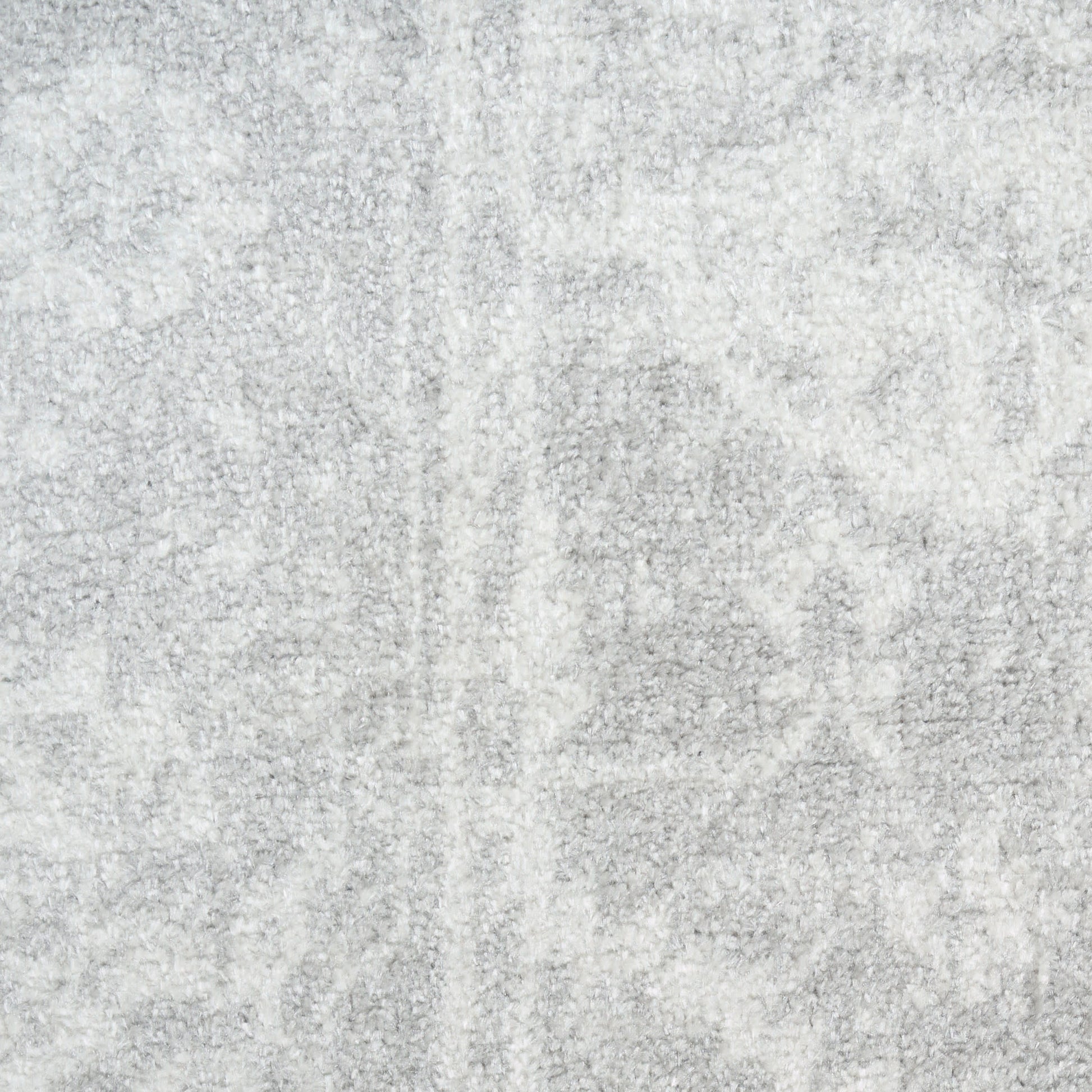 Light gray textured rug with soft plush pile and subtle tonal pattern; contemporary home decor.
