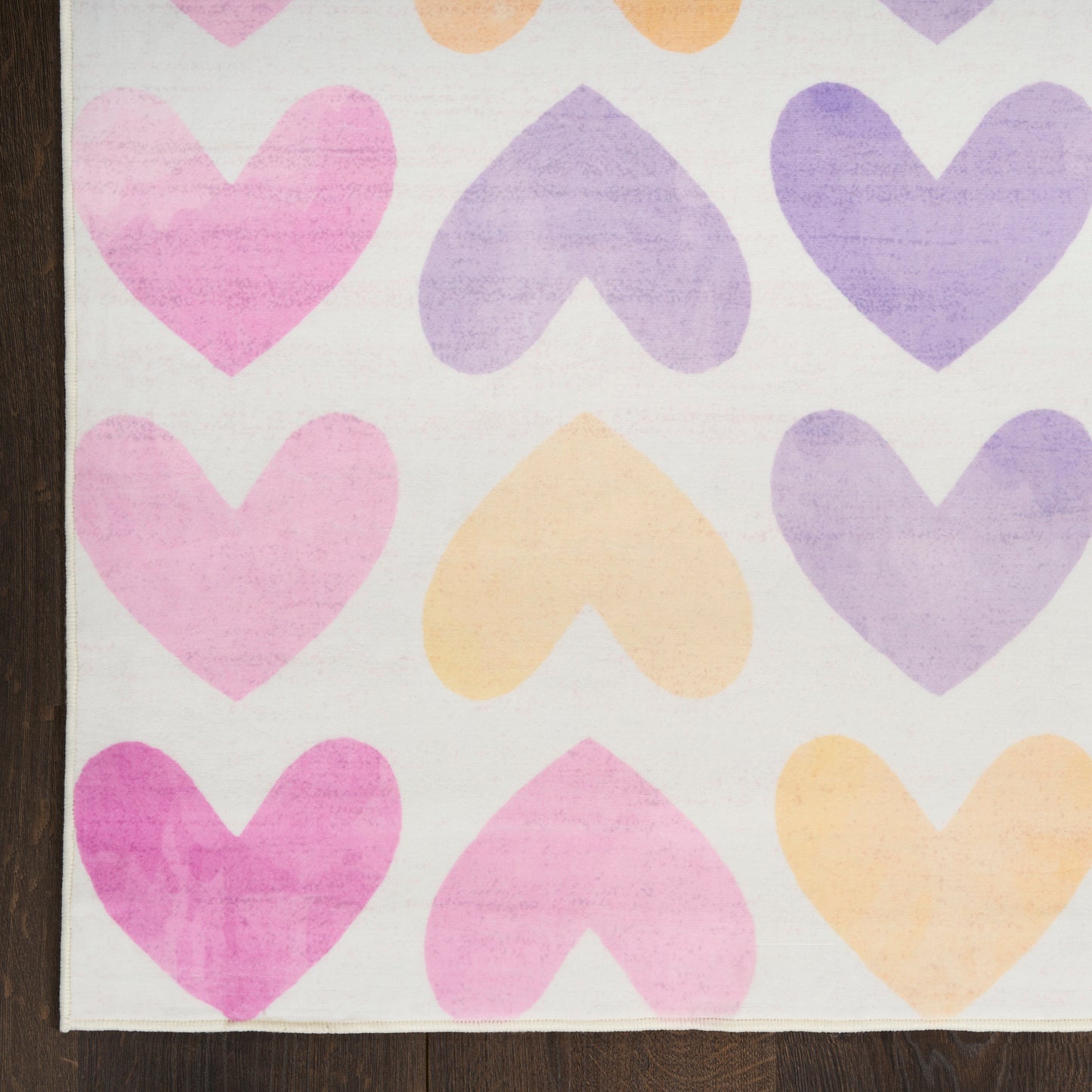 Pastel heart pattern with pink, purple and peach hearts on white; fabric-like material with a wooden edge on the left.