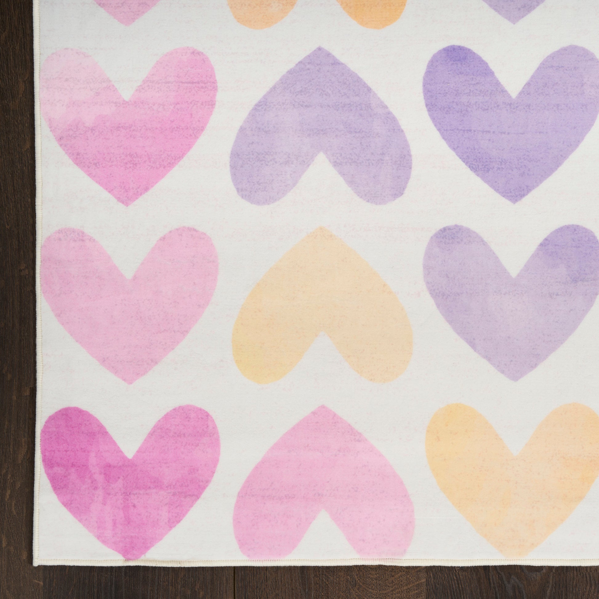 Pastel heart pattern with pink, purple and peach hearts on white; fabric-like material with a wooden edge on the left.