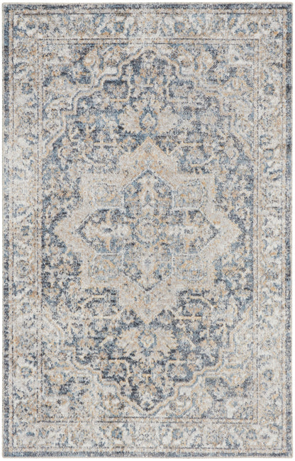 Rectangular blue-gray and ivory distressed Persian-style area rug with central medallion and floral border.