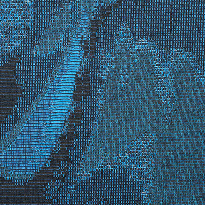 Close-up of a blue and teal woven rug with geometric patterns and diagonal stripe accents.