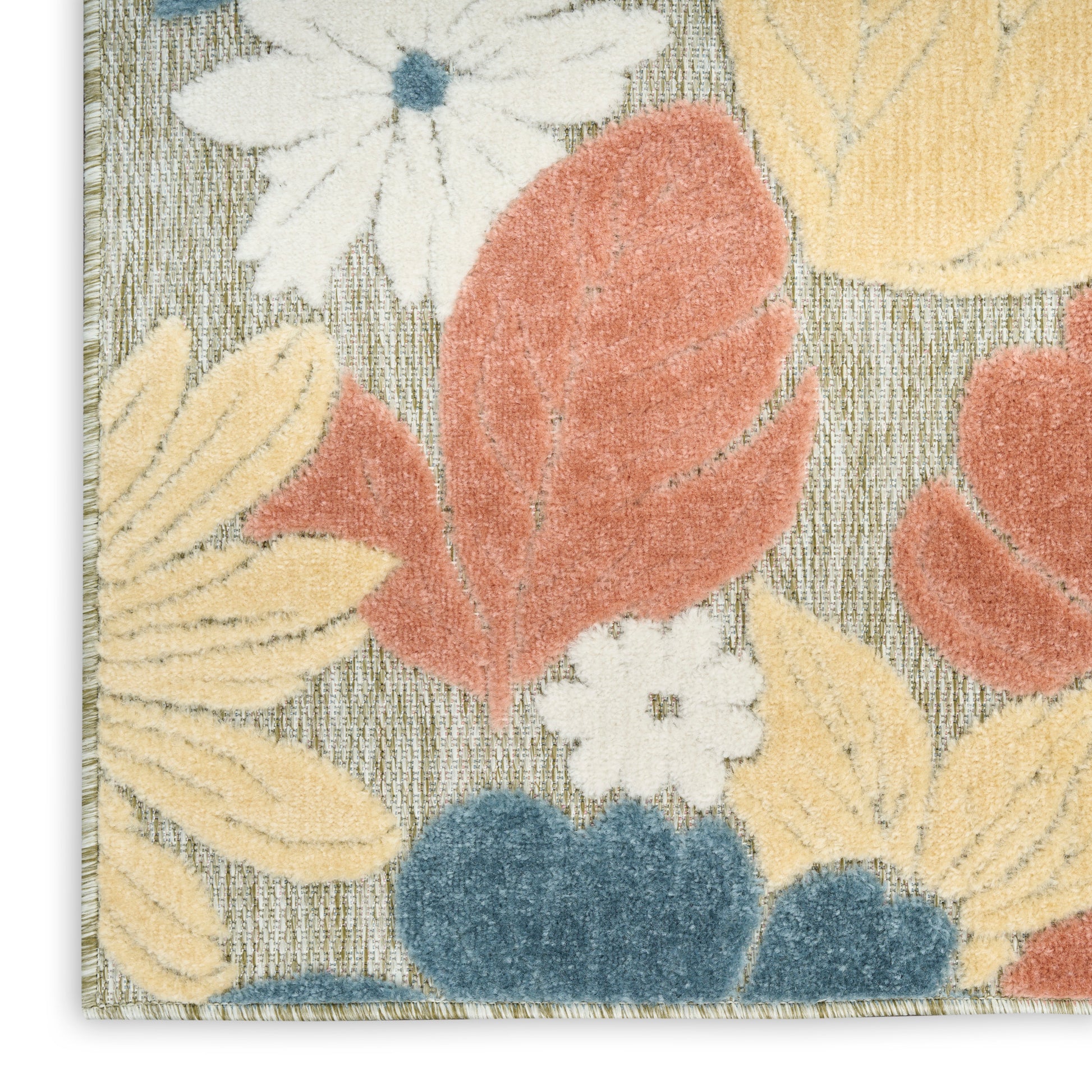 Close-up of floral area rug with white daisies, yellow leaves, orange-red petals and blue accents on a gray woven background