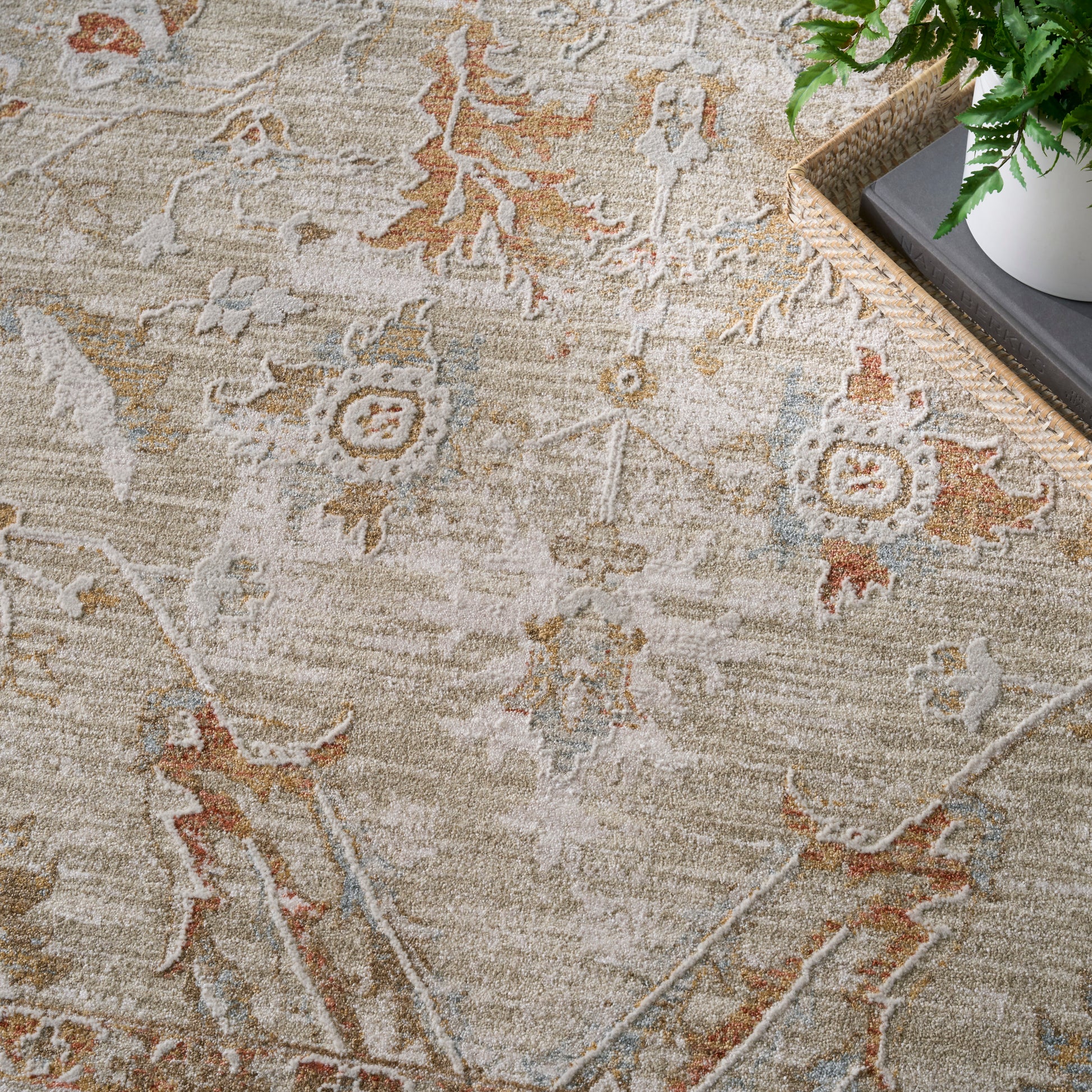 Beige Persian-inspired area rug with faded cream, tan, rust and blue motifs; soft pile, vintage floral pattern.