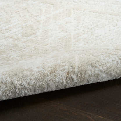 Cream white shag rug with thick plush pile resting on dark wood floor.
