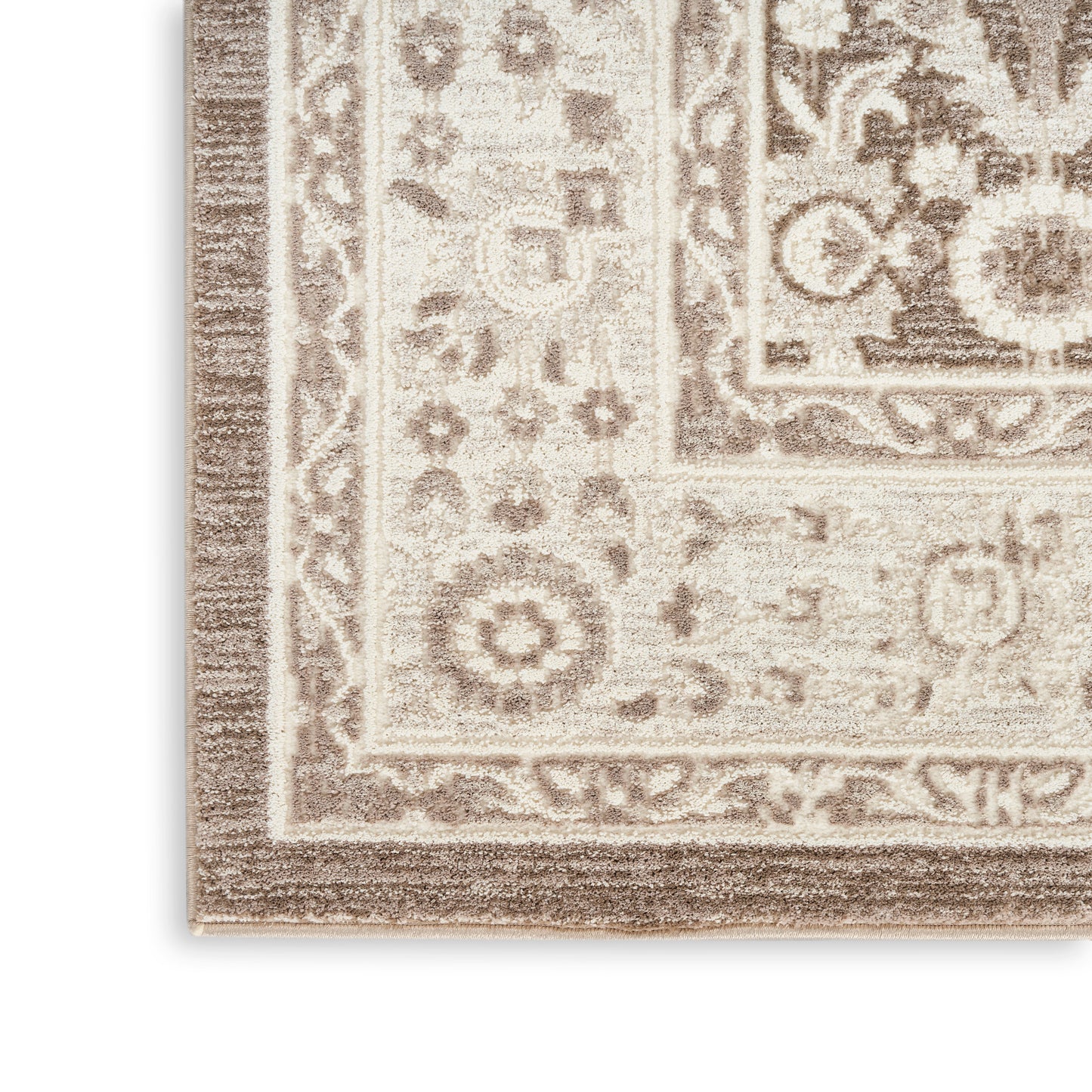 Beige and brown oriental rug corner with ornate floral border and medallion motifs.