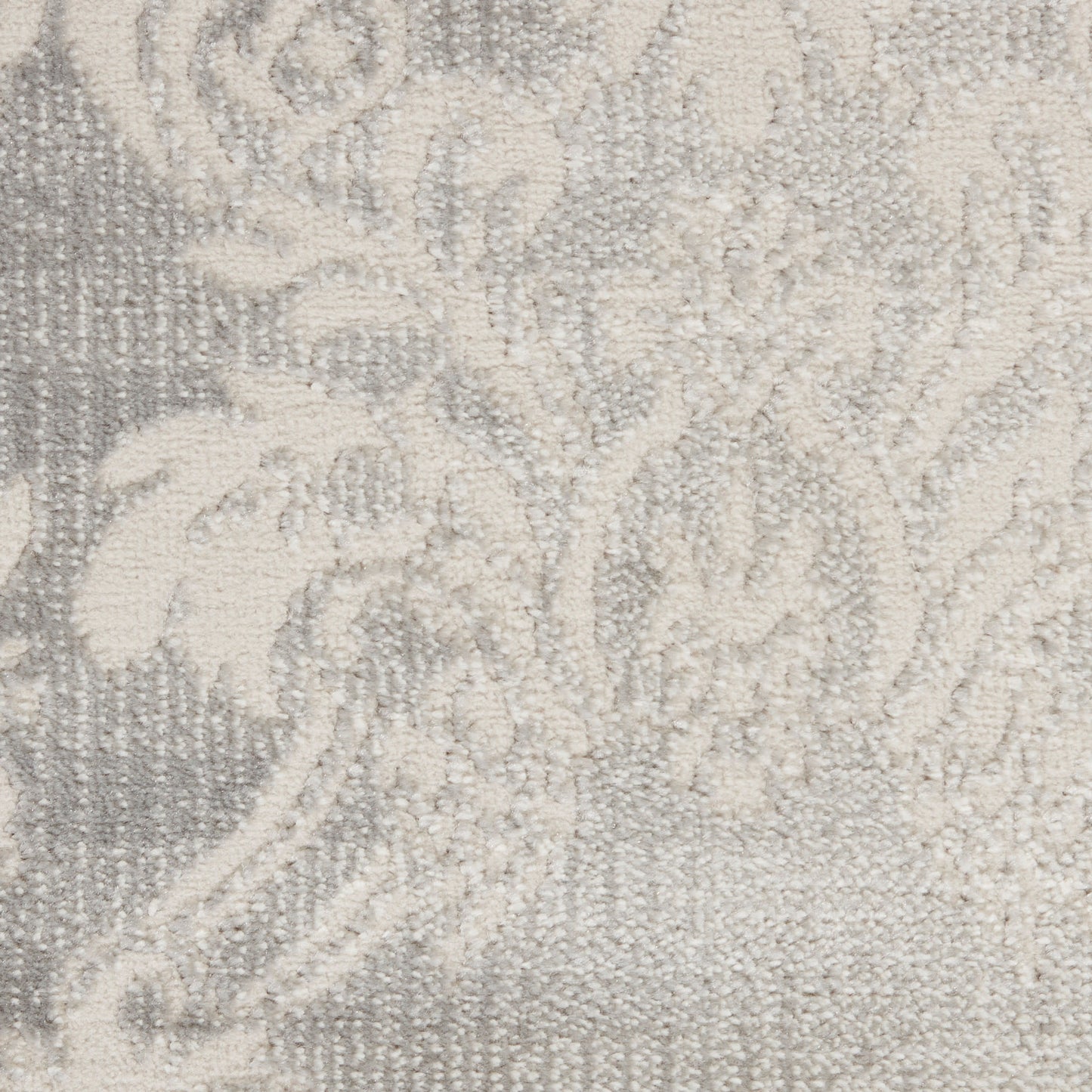 Neutral grey and ivory damask pattern on a woven rug with soft, plush texture.