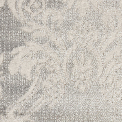 Neutral grey and ivory damask pattern on a woven rug with soft, plush texture.
