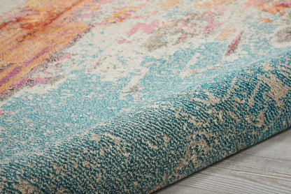 Close-up of a vibrant abstract rug in teal, orange and blue hues with a textured loop pile on wood floor.