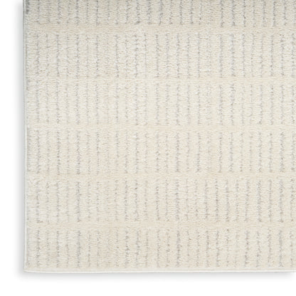 Cream rug with vertical striped loop texture and soft plush pile; 4' x 6'.