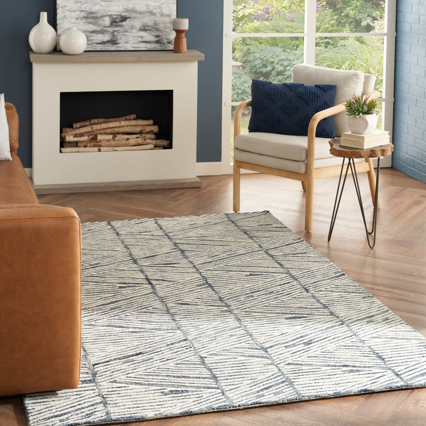 Cream and navy blue geometric flat-weave area rug with intersecting lines; modern living room decor.