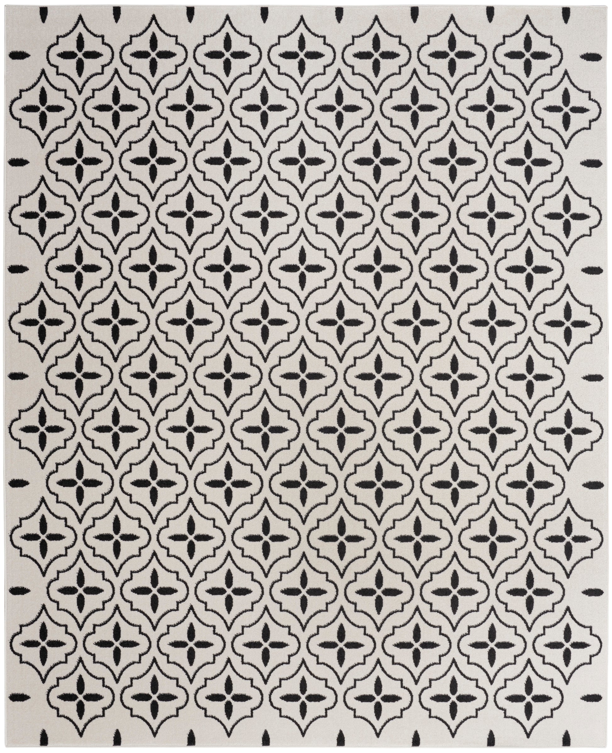 Cream area rug with a black repeating trellis/quatrefoil motif; woven textile, modern geometric design.