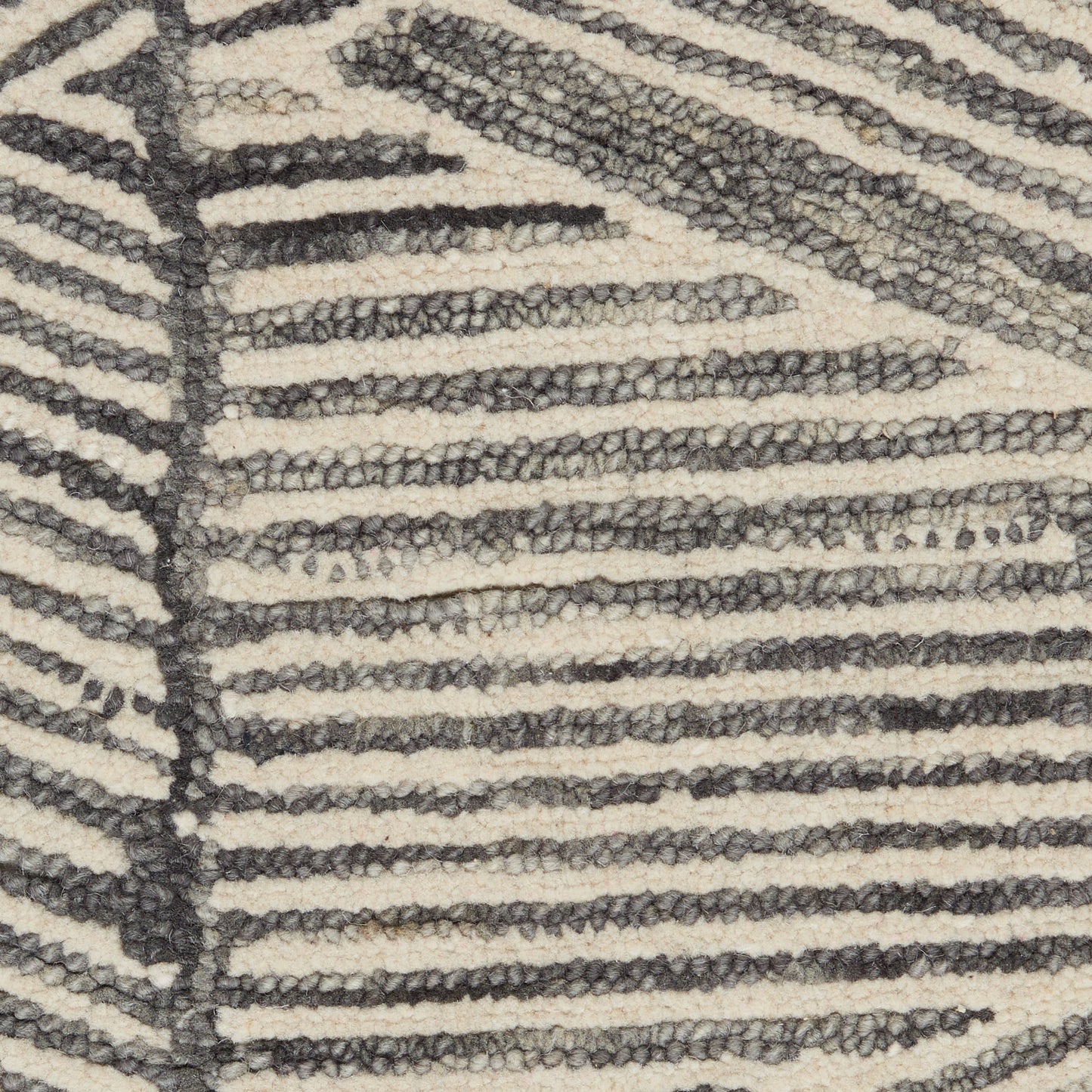 Beige and dark gray zebra-striped rug with chunky loop pile.