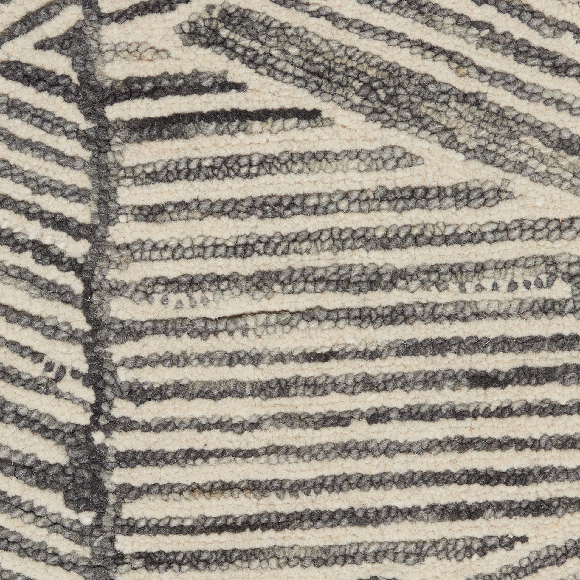 Beige and dark gray zebra-striped rug with chunky loop pile.