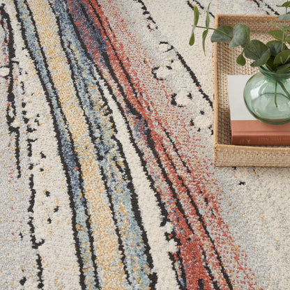 Textured abstract striped rug with cream base and multicolor lines; woven basket with plant and books nearby.