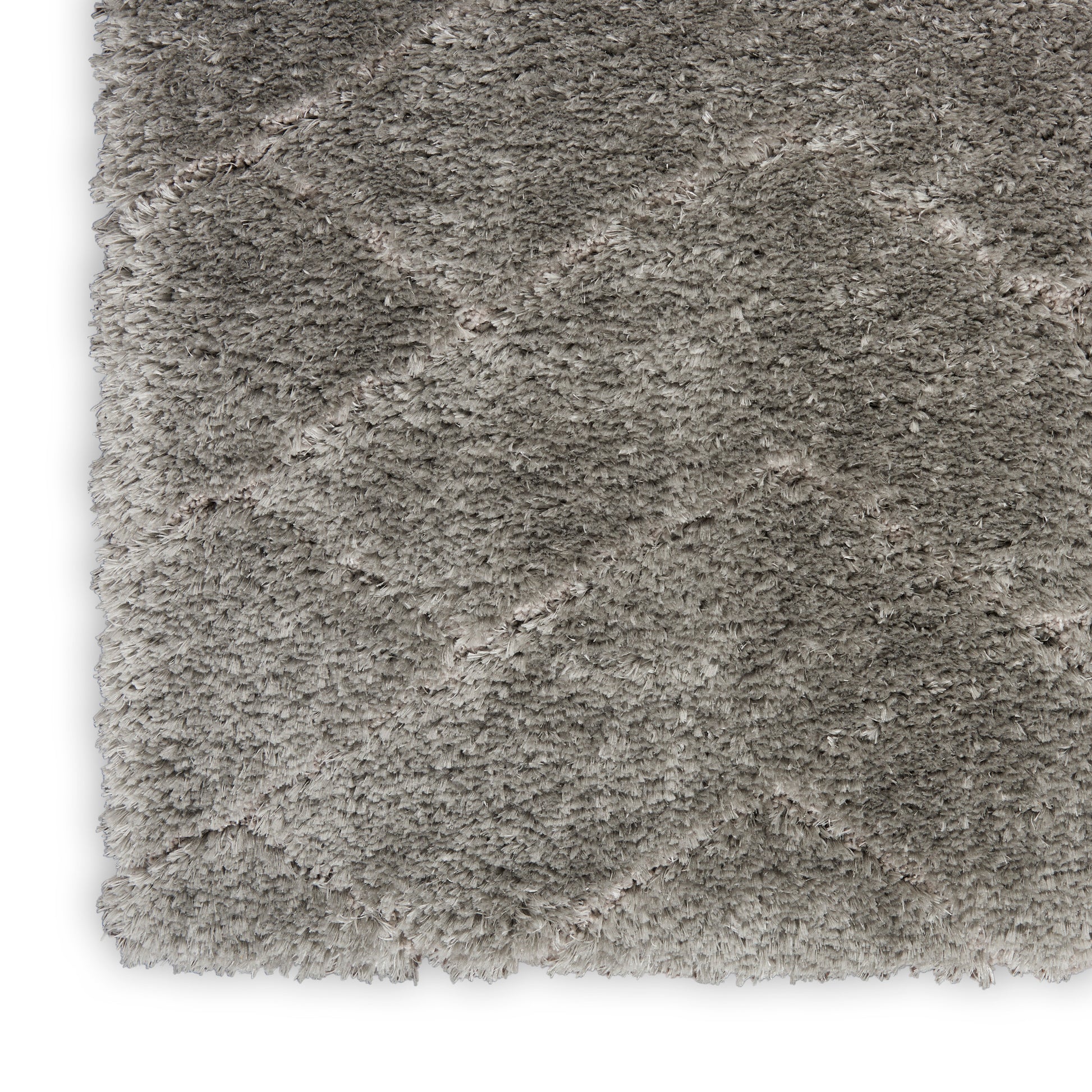 Beige-gray shag rug close-up; high-pile plush texture for cozy living spaces.
