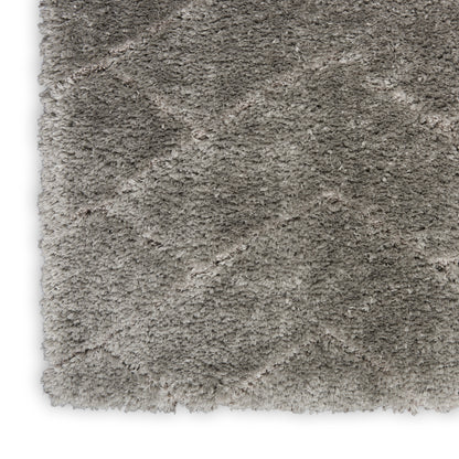 Beige-gray shag rug close-up; high-pile plush texture for cozy living spaces.